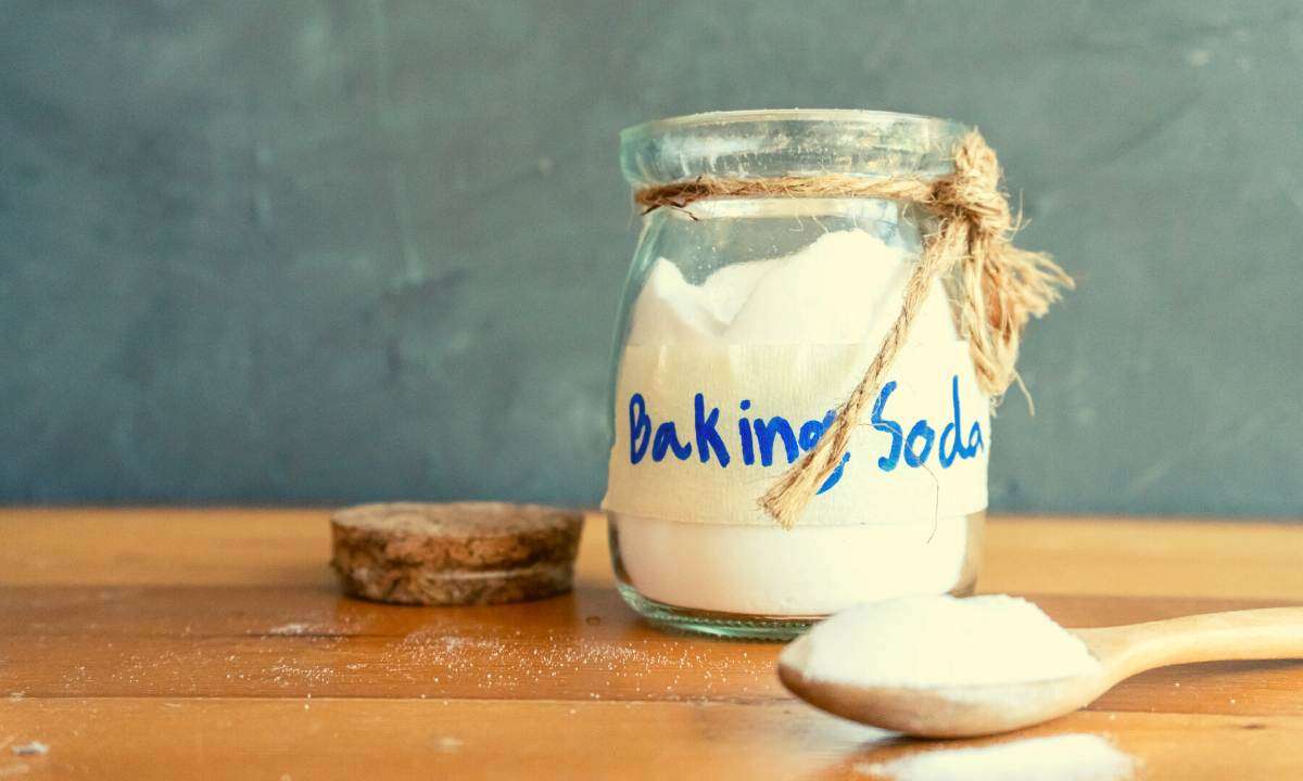 A glass jar with a handwritten label on it that says "baking soda."