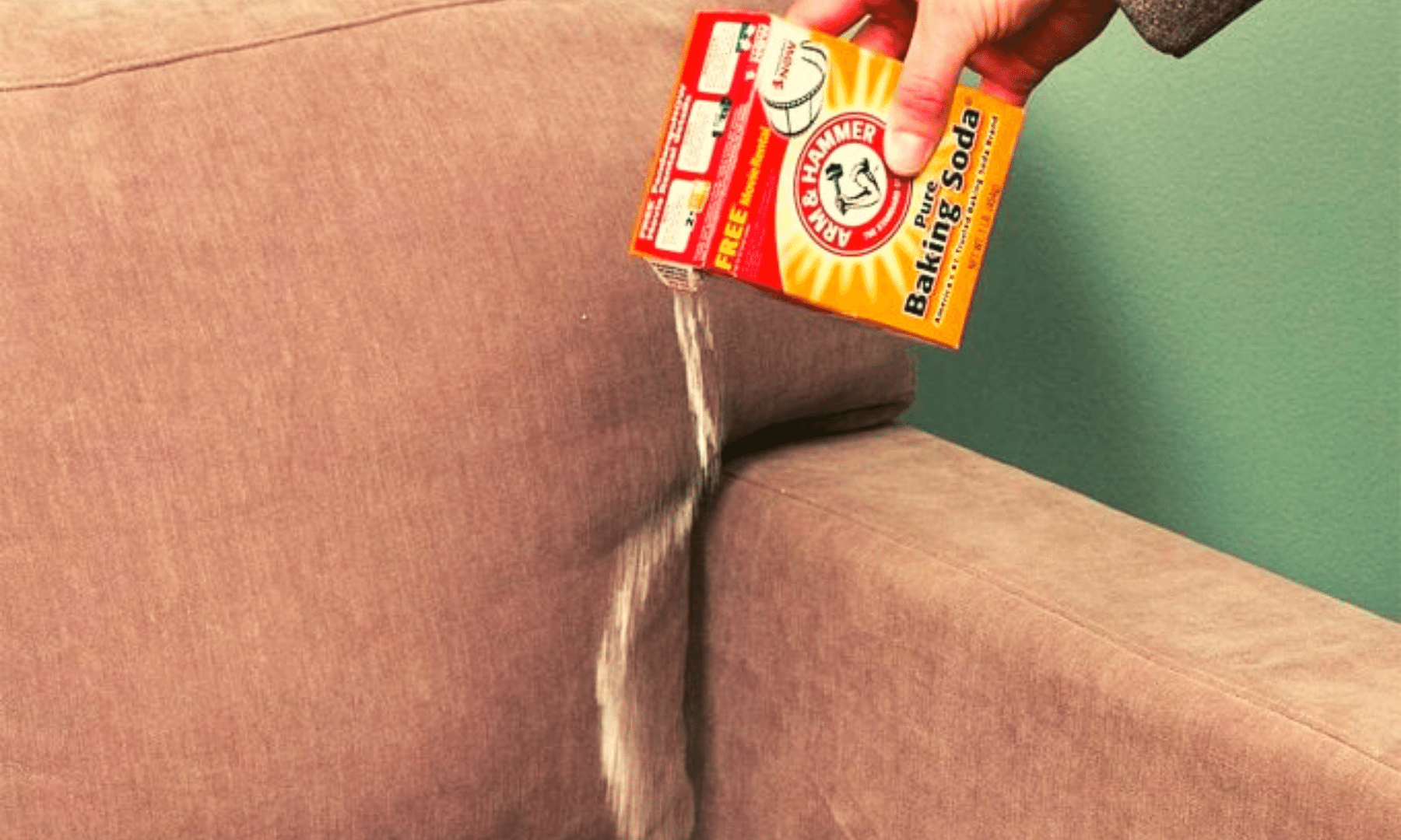 Sprinkling baking soda on a couch