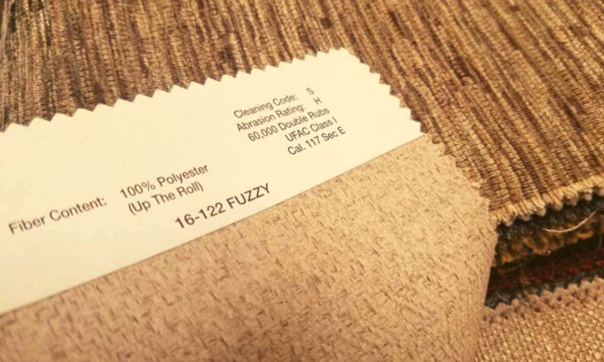 Closeup of a couch tag with the cleaning code "S" on it.